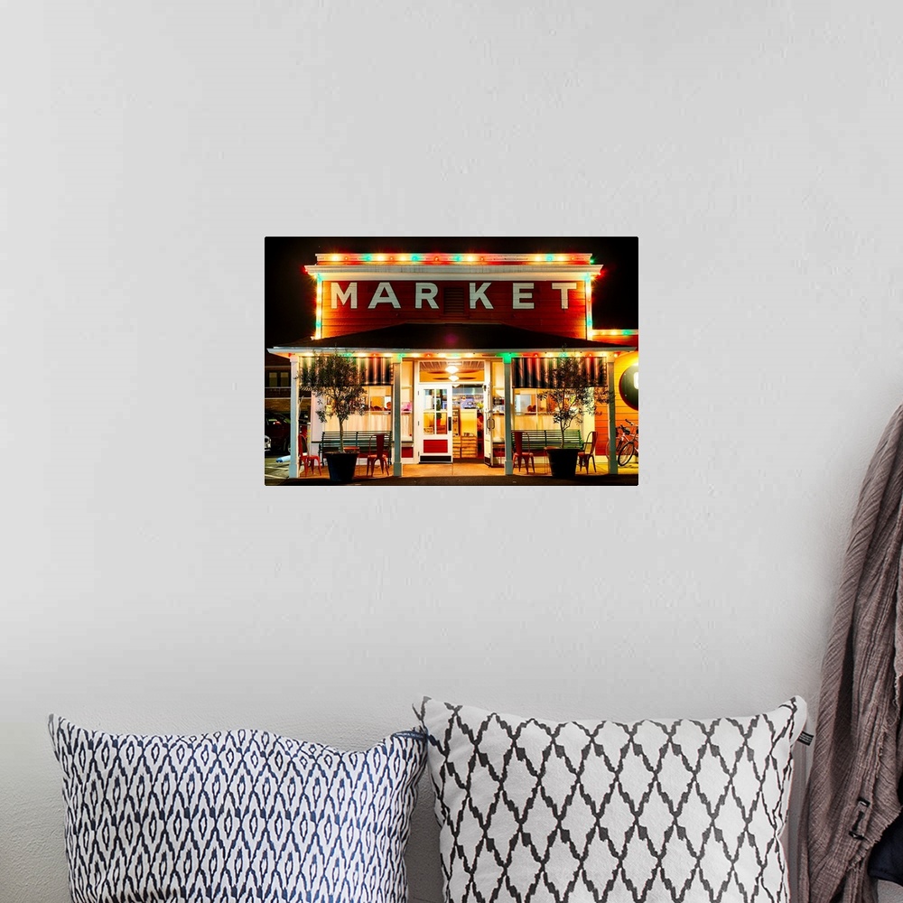 A bohemian room featuring Fine art photo of a market building in Napa Valley lit up at night.