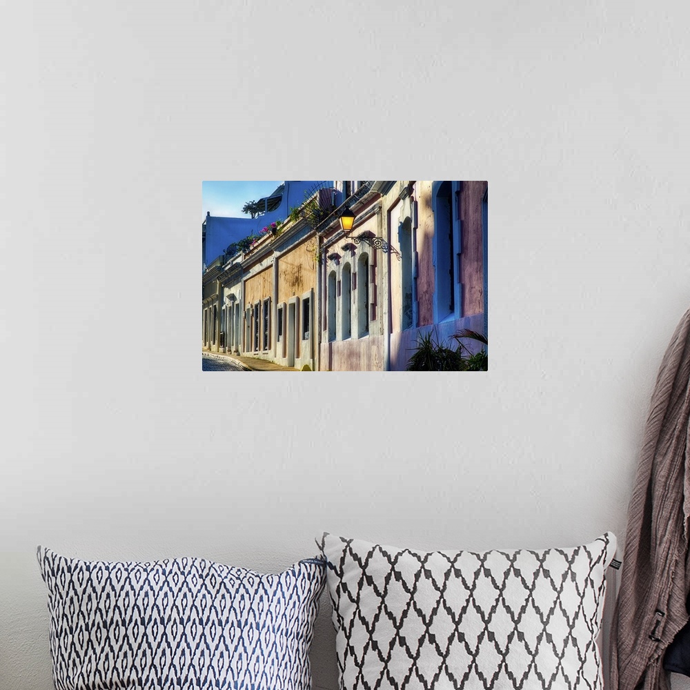 A bohemian room featuring A photograph of an old village, looking down a row of houses.