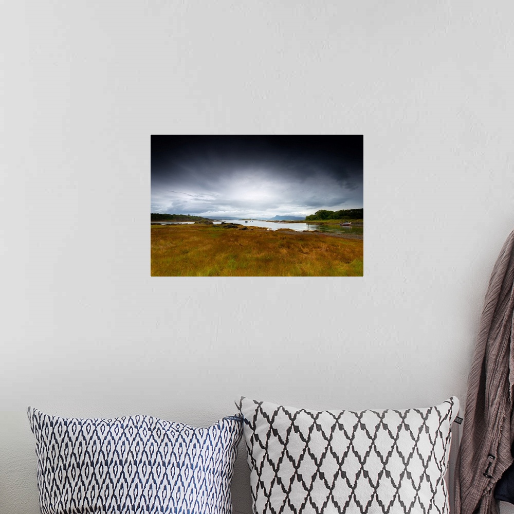 A bohemian room featuring Fine art photo of a grassy marshland at the edge of the water under a stormy sky.
