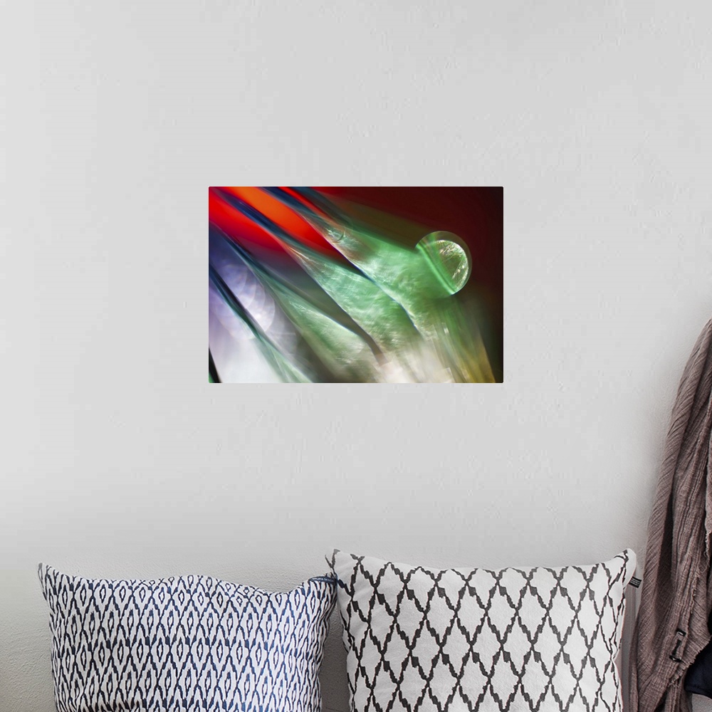 A bohemian room featuring Abstract photograph of green ridges against red and purple.