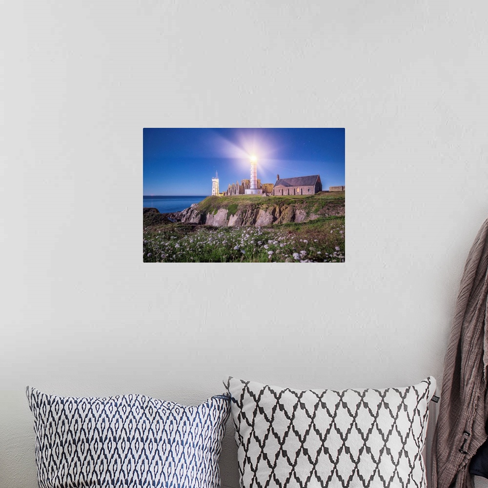 A bohemian room featuring Light shining from the lighthouse on the Bretagne coast in France.