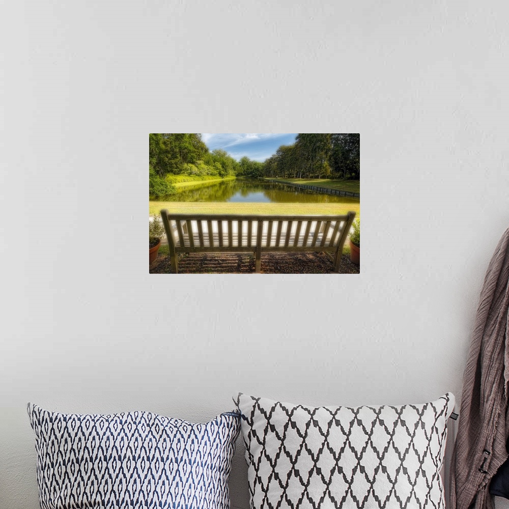 A bohemian room featuring A photograph of a bench looking out to a pond in South Carolina.