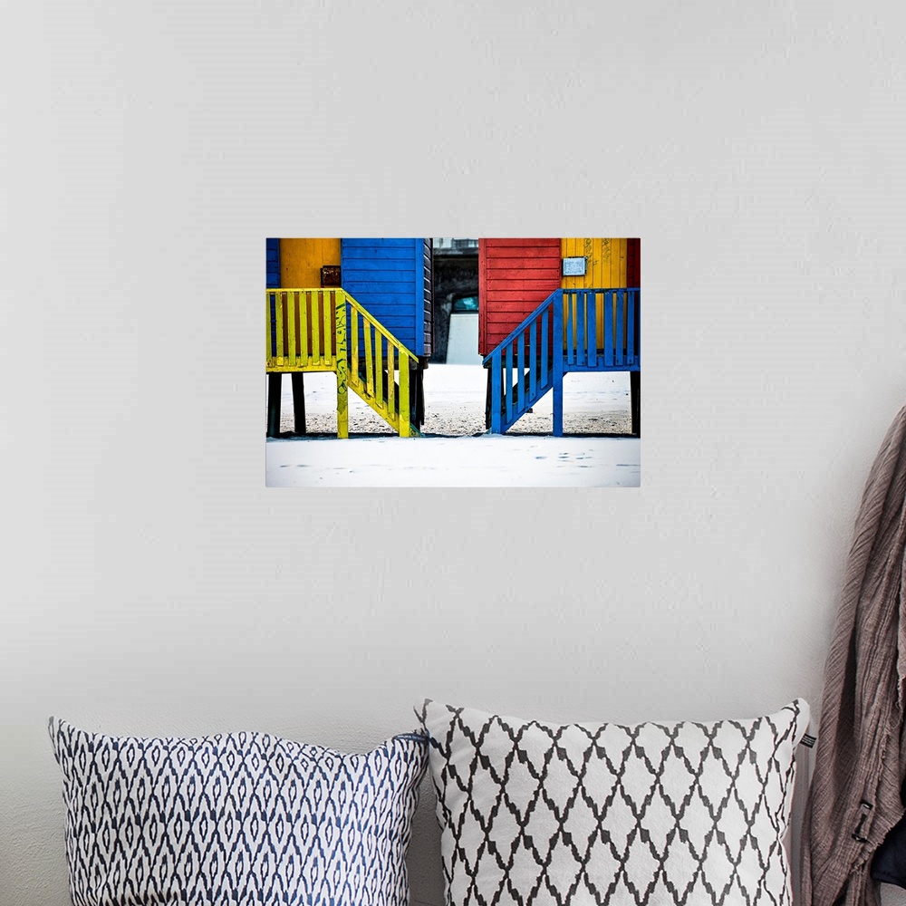 A bohemian room featuring A photo of colorful buildings that have been painted in primary colors over a white snowy landscape.