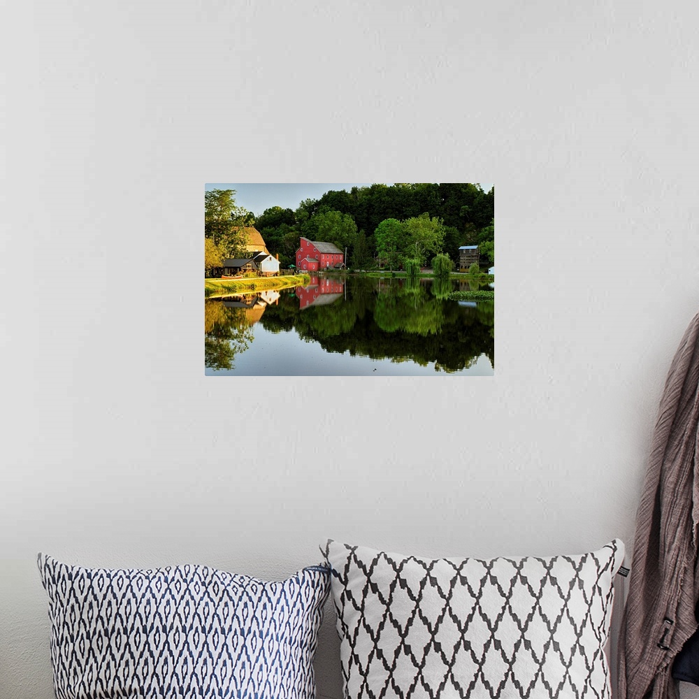 A bohemian room featuring Fine art photo of a bright red house at the edge of a calm lake, with the reflection of the fores...