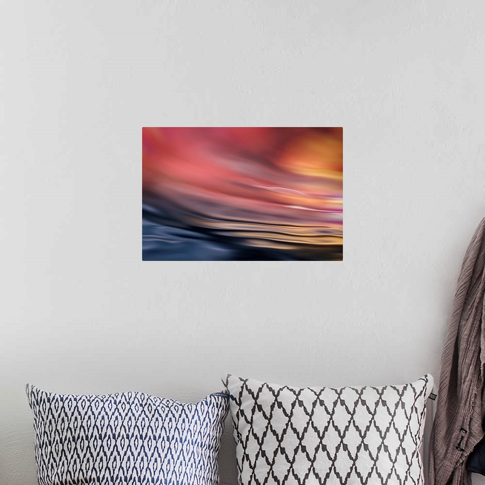 A bohemian room featuring Abstract photograph of softly rippling water in red and orange tones.