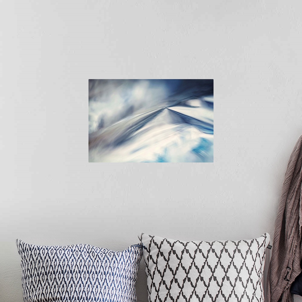 A bohemian room featuring Abstract artwork of blues and whites to create an illusion of snow.