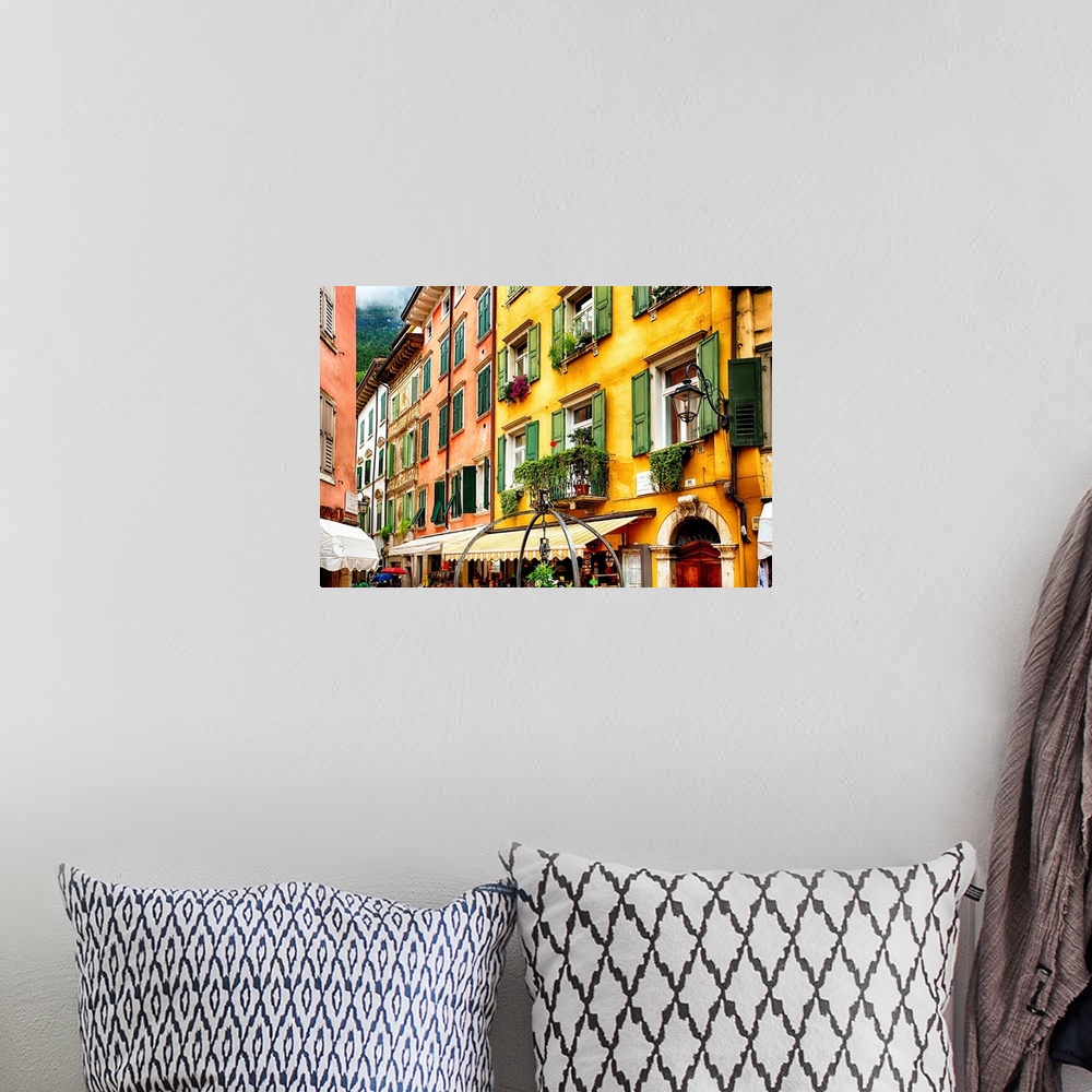 A bohemian room featuring Fine art photo of the brightly colored buildings and window shutters of an Italian street.