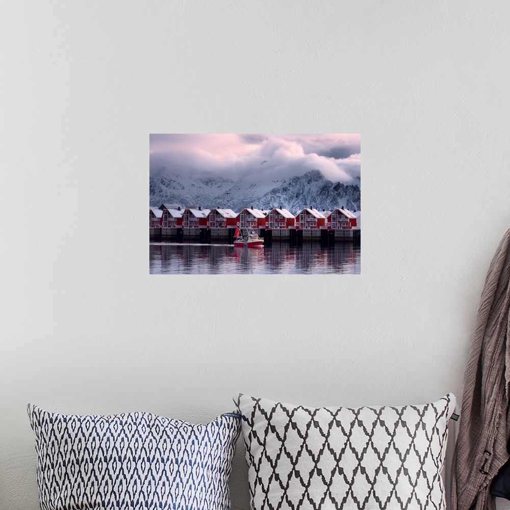 A bohemian room featuring A photograph of a red building sitting on the shoreline of a snowy landscape with mountains in th...