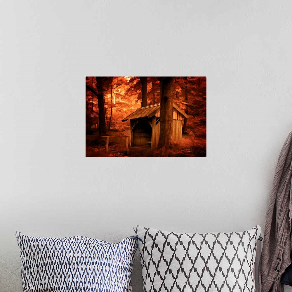 A bohemian room featuring A photograph of a stable surrounded by trees in autumn foliage.
