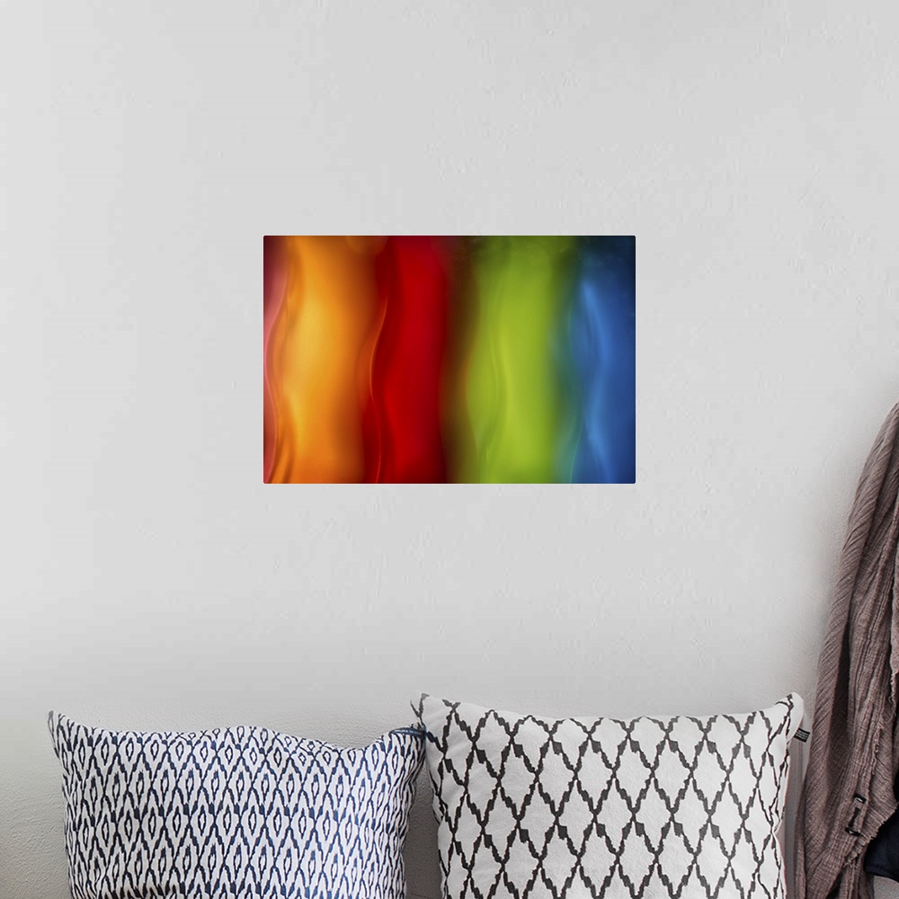 A bohemian room featuring Abstract photograph in orange, red, green, and blue vertical layers.