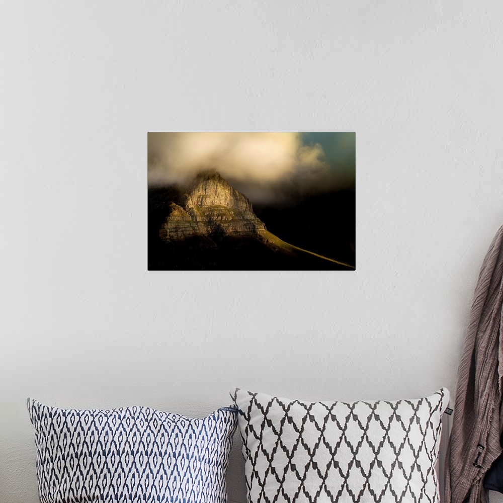 A bohemian room featuring A photograph of clouds rolling over a mountain peak.
