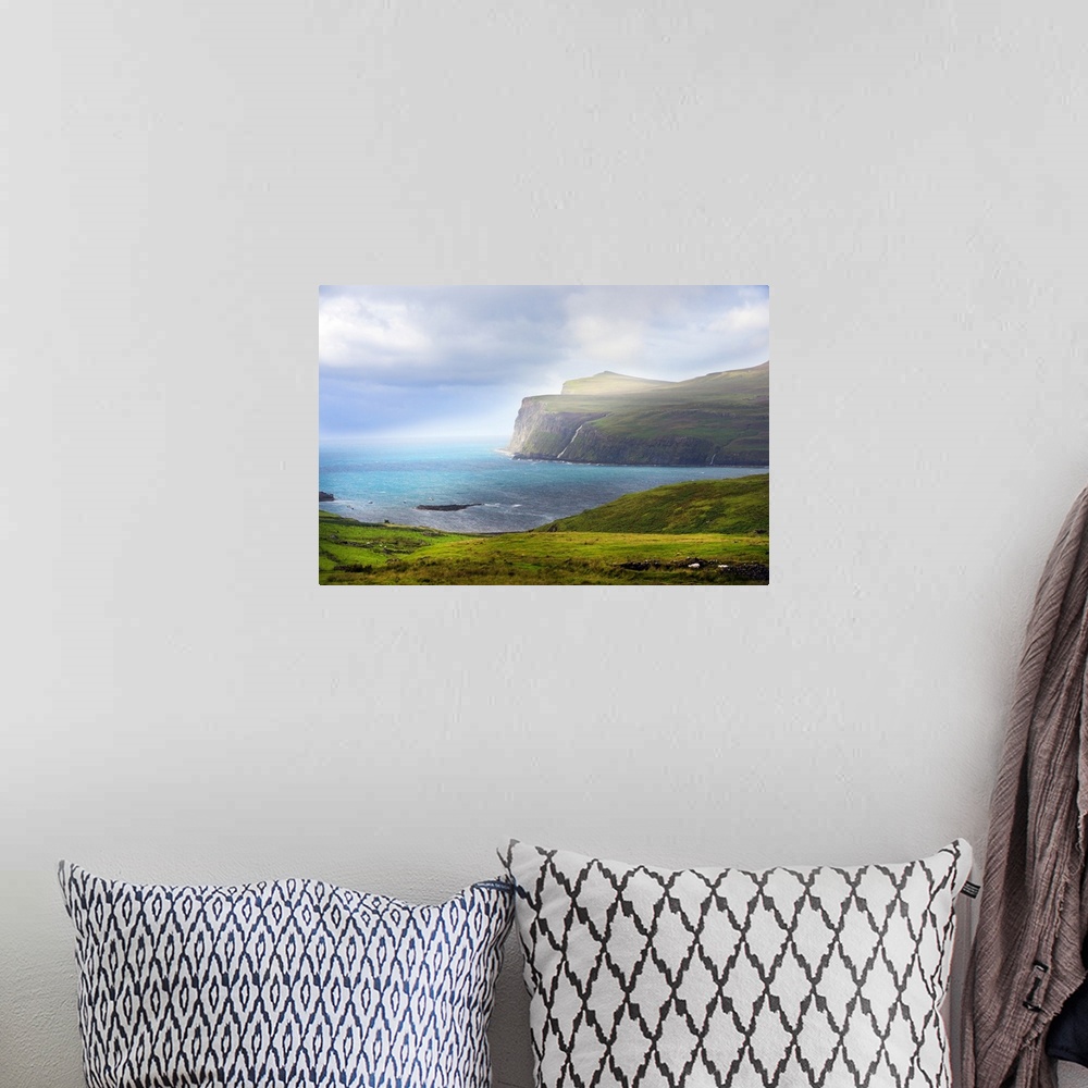 A bohemian room featuring Fine art photo of cliffs at the edge of the sea under bright sunlight.