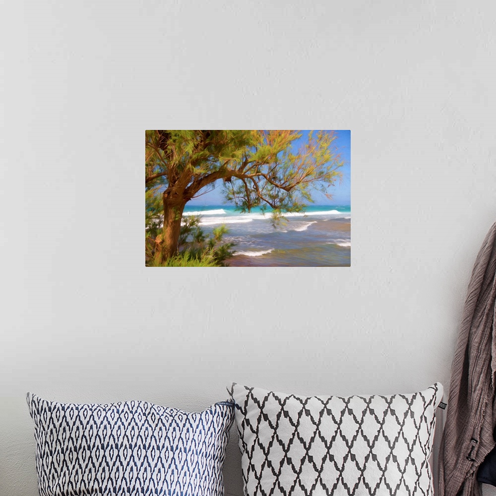A bohemian room featuring A photograph of a beach seen through the underside of a trees hanging branches.