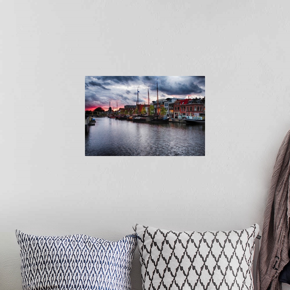 A bohemian room featuring Canal with old ship, windmill, and a drawbridge at sunset, Leiden, Netherlands.