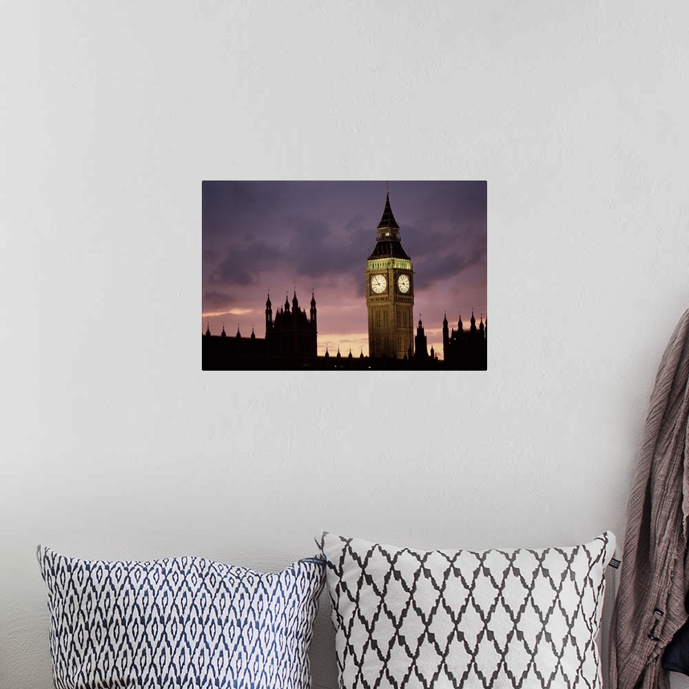 A bohemian room featuring A lit up Big Ben clock exends in to the dusk London sky rising high above the spires of Parlament...