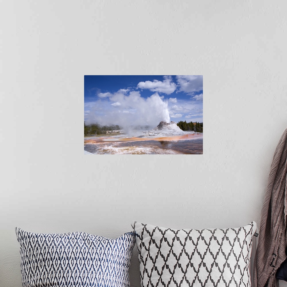 A bohemian room featuring Castle Geyser Erupting