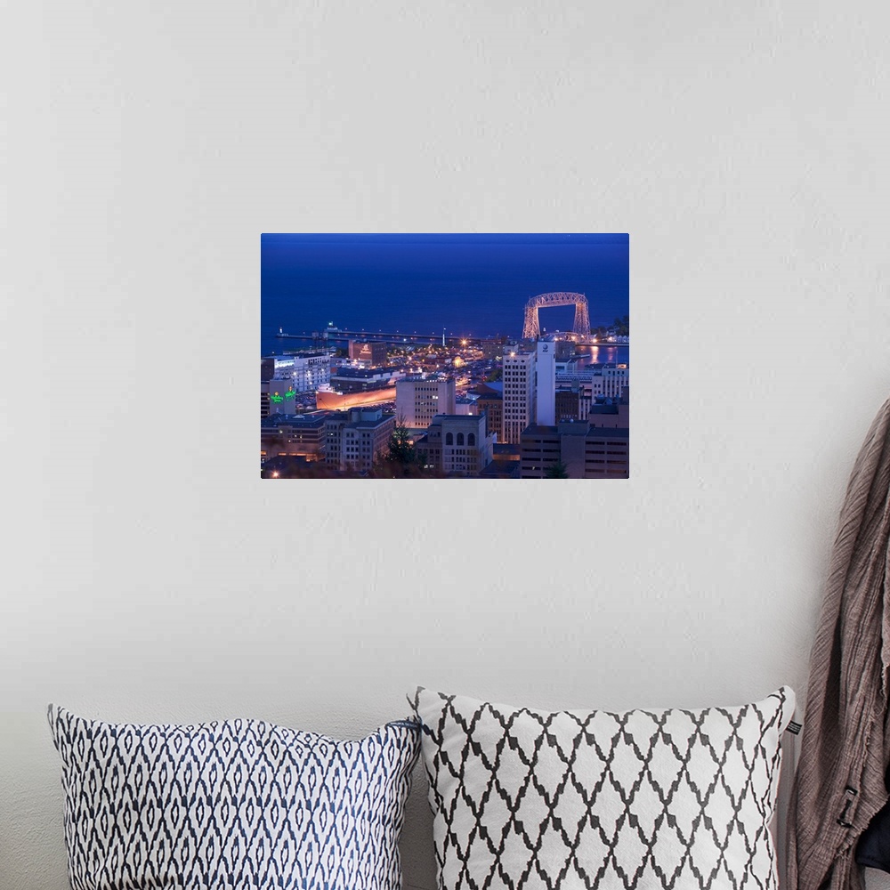 A bohemian room featuring This wall art for the office or home is an aerial photograph of city harbor at night.