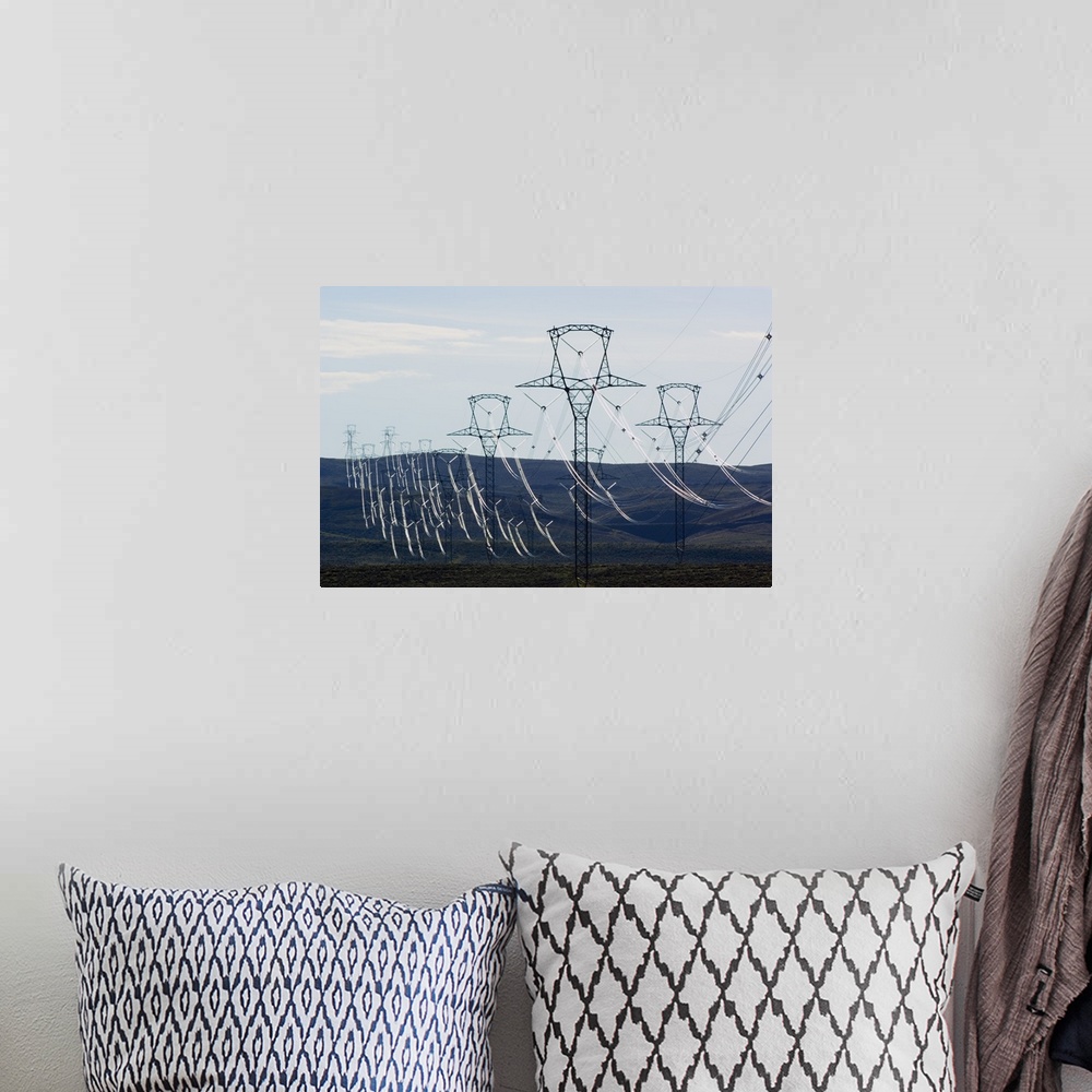 A bohemian room featuring High voltage power lines spanning rolling hills.