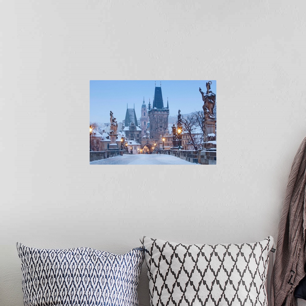 A bohemian room featuring Prague, Charles Bridge tower and St. Nicolas church on winter morning.