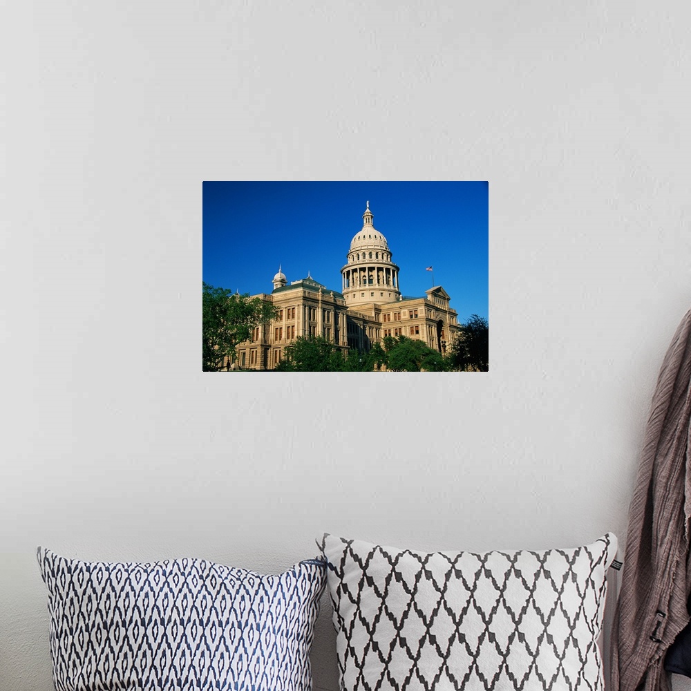A bohemian room featuring Landscape photograph of the state capitol building against a bright blue sky, in Austin, Texas.