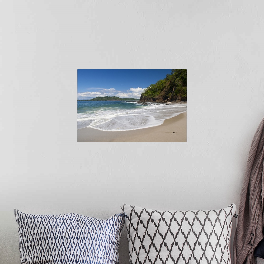 A bohemian room featuring Big photo on canvas of waves washing onto a tropical beach.
