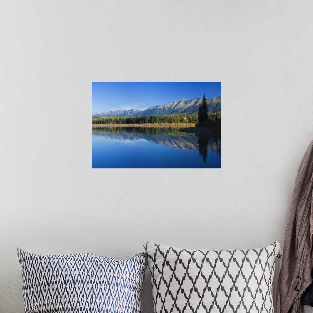 A bohemian room featuring Big canvas photo of mountains and their reflection onto the lake in front of them.
