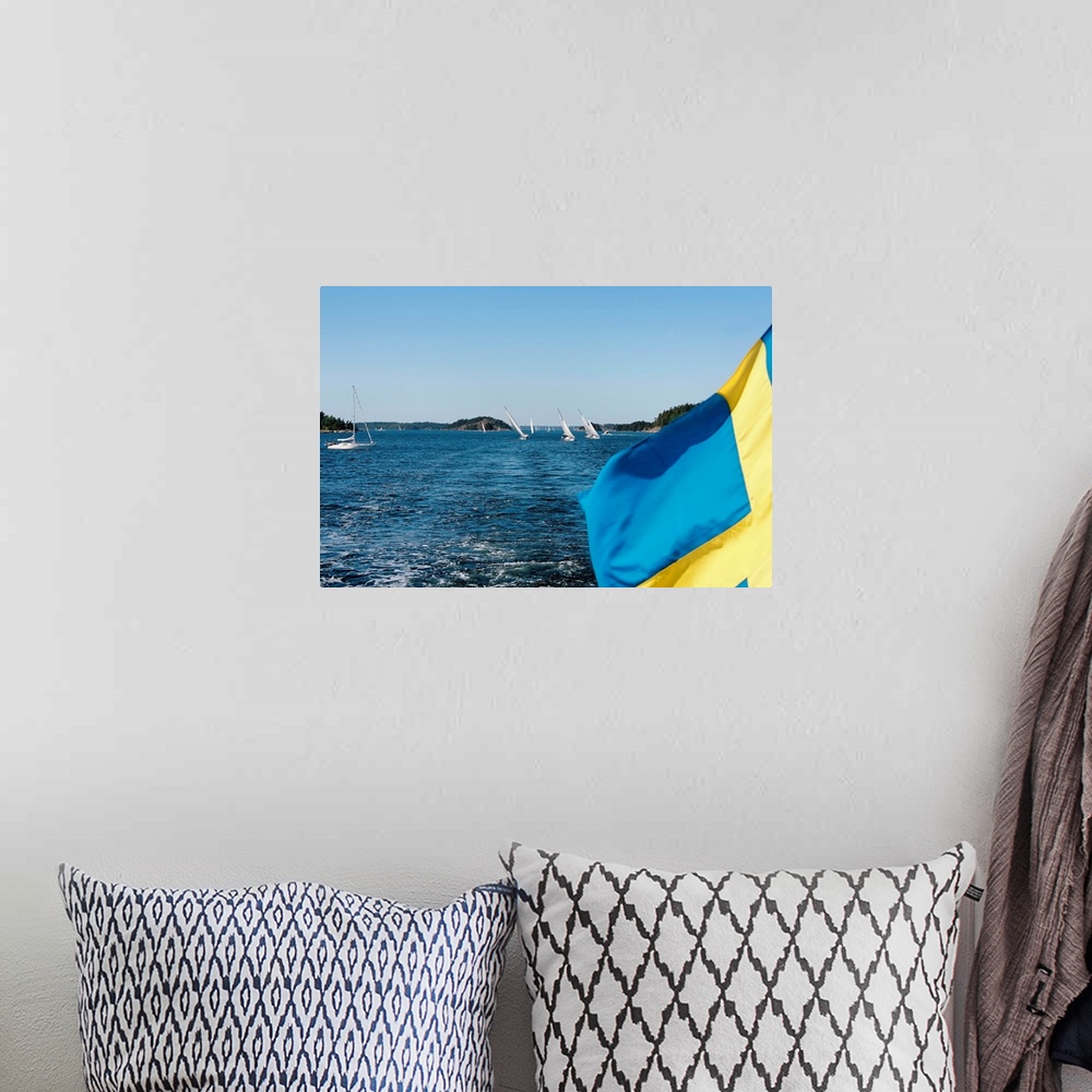 A bohemian room featuring Close-up of a Swedish flag with sailboats in the background, Stockholm Archipelago, Stockholm, Sw...