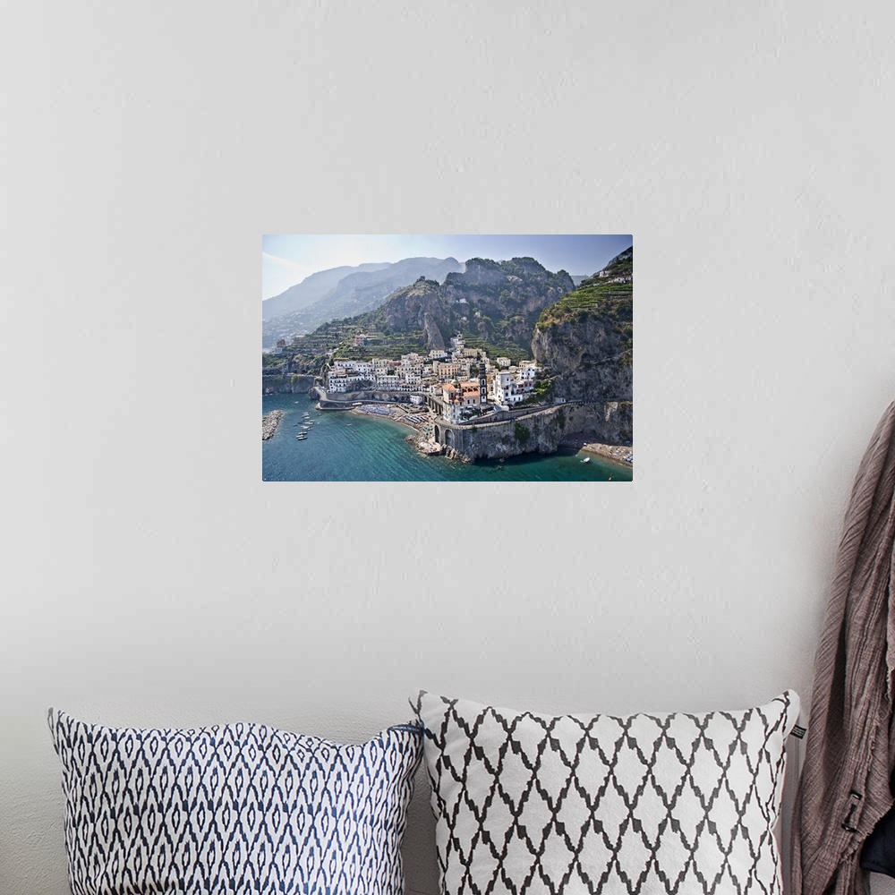 A bohemian room featuring Big canvas photo of a small town on cliffs and mountains that over look the ocean.