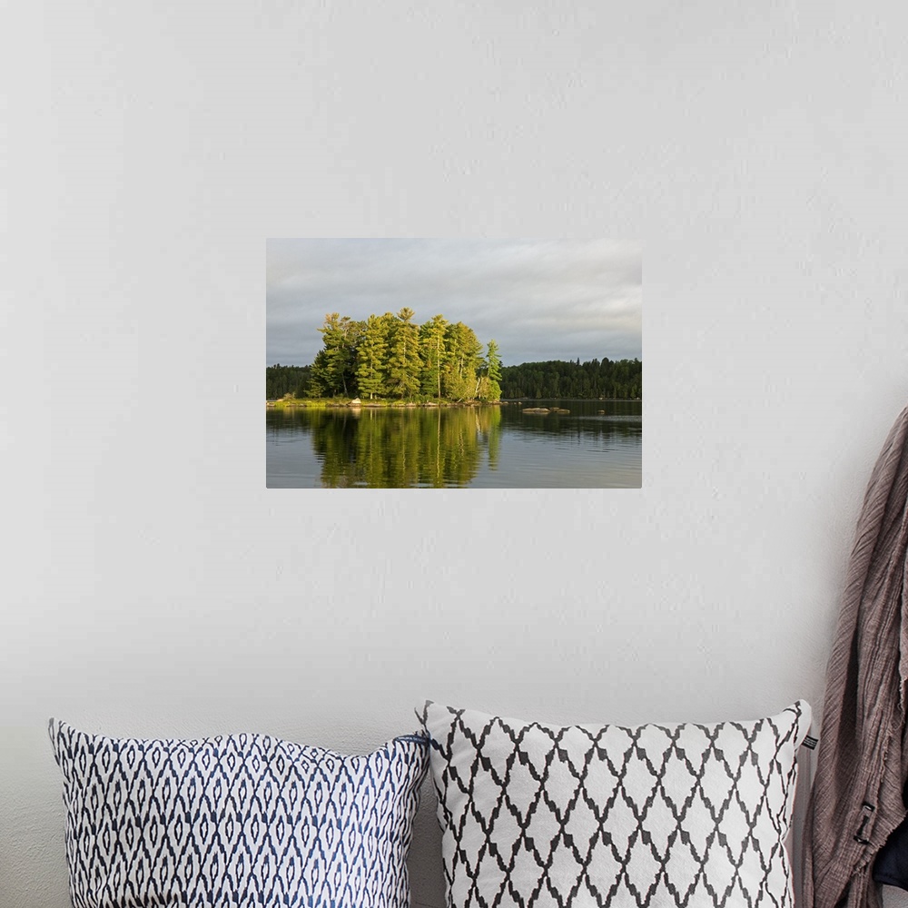 A bohemian room featuring Trees growing on small island, water reflection, Lake Agnes, Boundary Waters Canoe Area Wildernes...