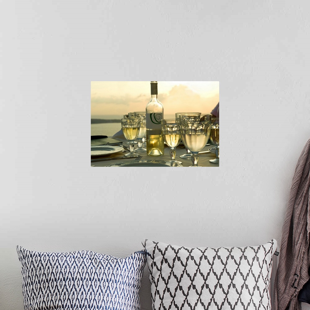 A bohemian room featuring Horizontal photograph on a big wall hanging of place settings on a  table, surrounded by many ful...