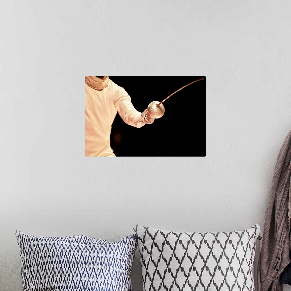 A bohemian room featuring Male fencer in action