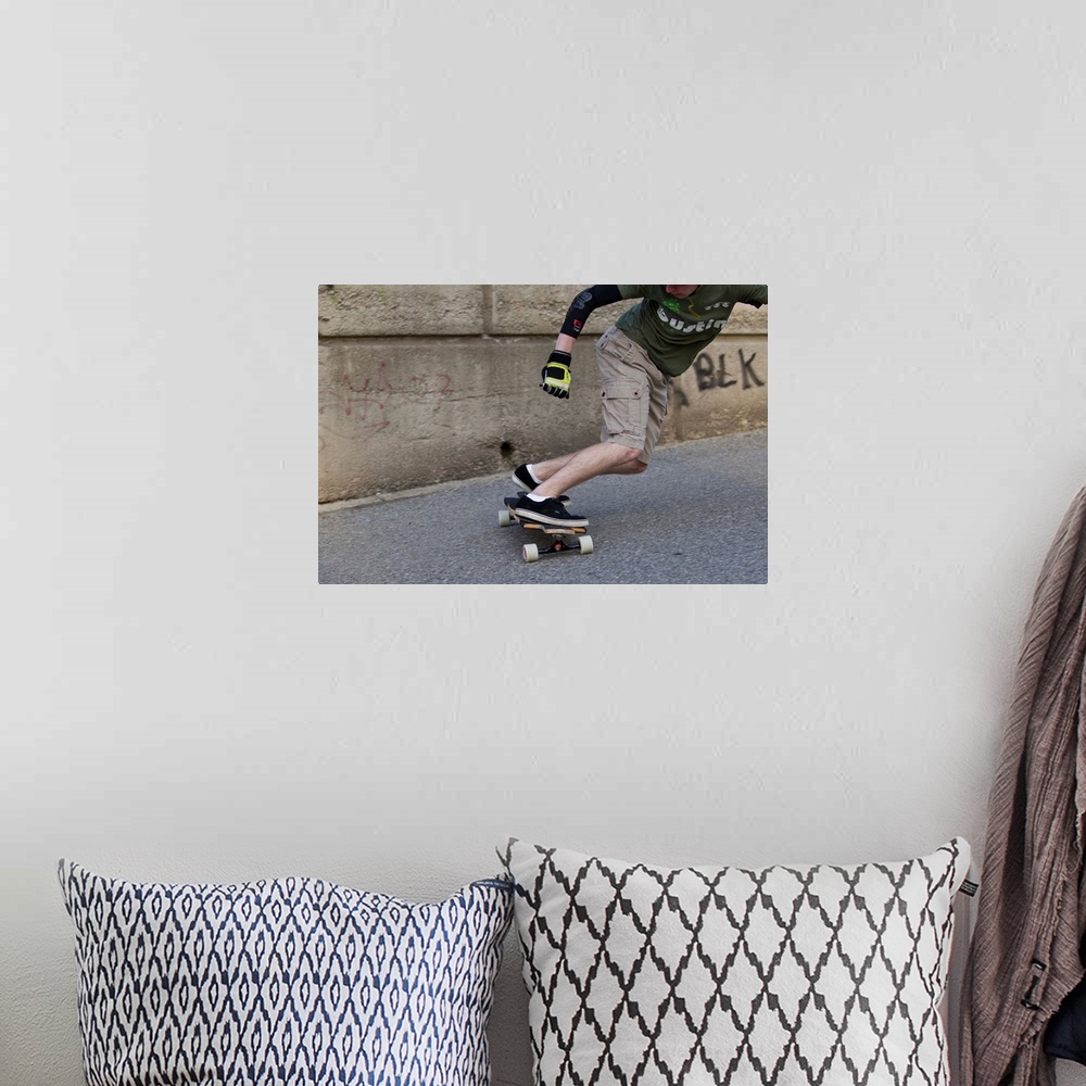 A bohemian room featuring Young male skateboarder on urban street