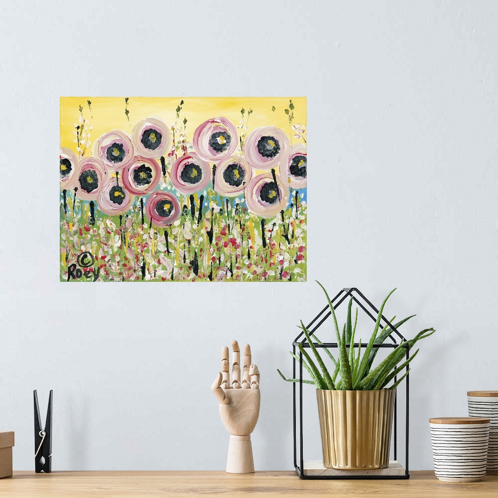 A bohemian room featuring Horizontal abstract painting of a field of flowers in textured colors of pink, green and yellow.