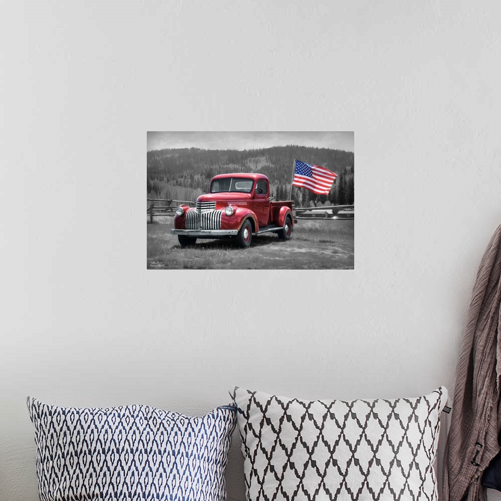 A bohemian room featuring A vintage red truck with an American Flag in a field in the countryside.
