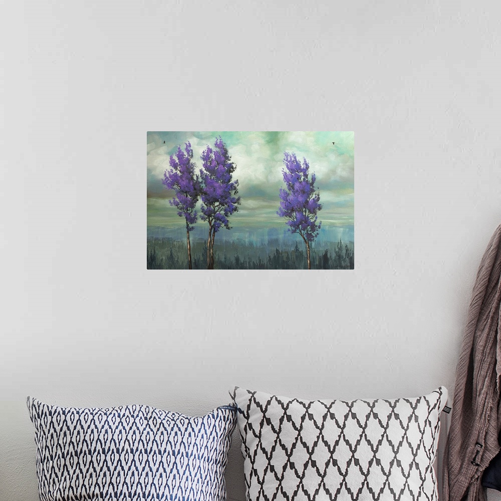A bohemian room featuring Painting of three trees with purple leaves against a cloudy sky.