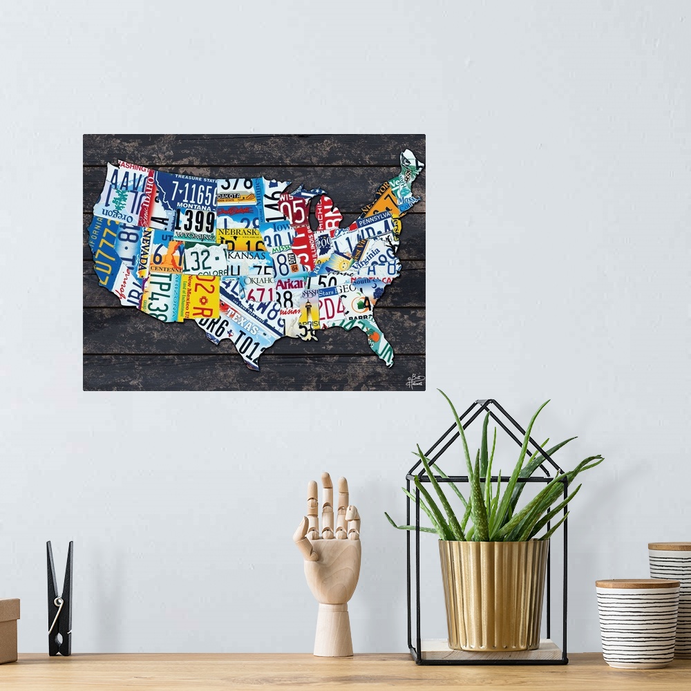 A bohemian room featuring Map of the USA made from different license plates, against a dark wood planked background.