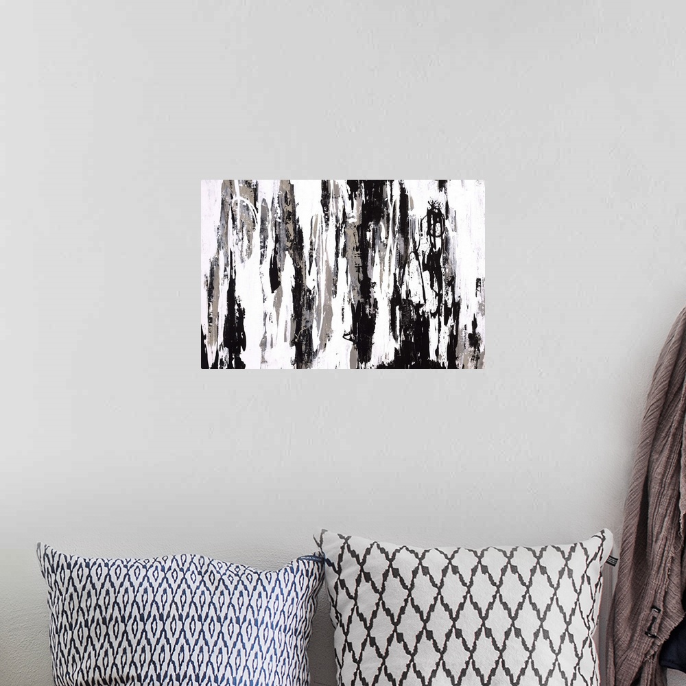 A bohemian room featuring Abstract painting with harsh black and gray splatters and swipes in a downward motion.