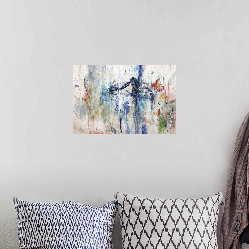 A bohemian room featuring Large abstract painting with all of the colors of the rainbow on a cream background.