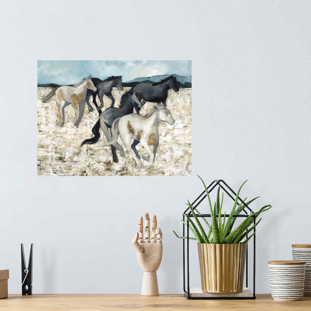 A bohemian room featuring Contemporary painting of a herd of galloping horses.
