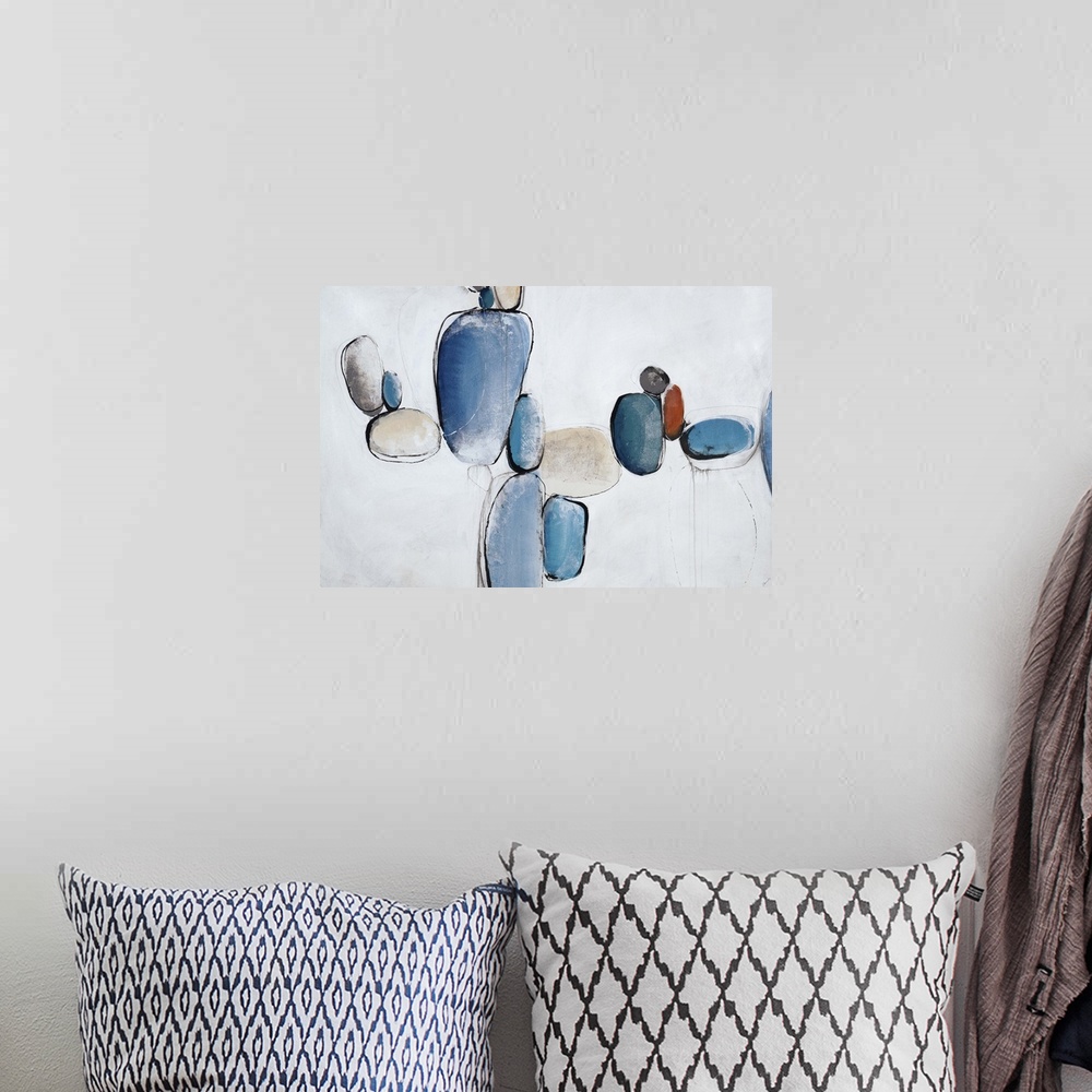 A bohemian room featuring Abstract painting using light blue to create shapes that look like rocks all balancing in air.