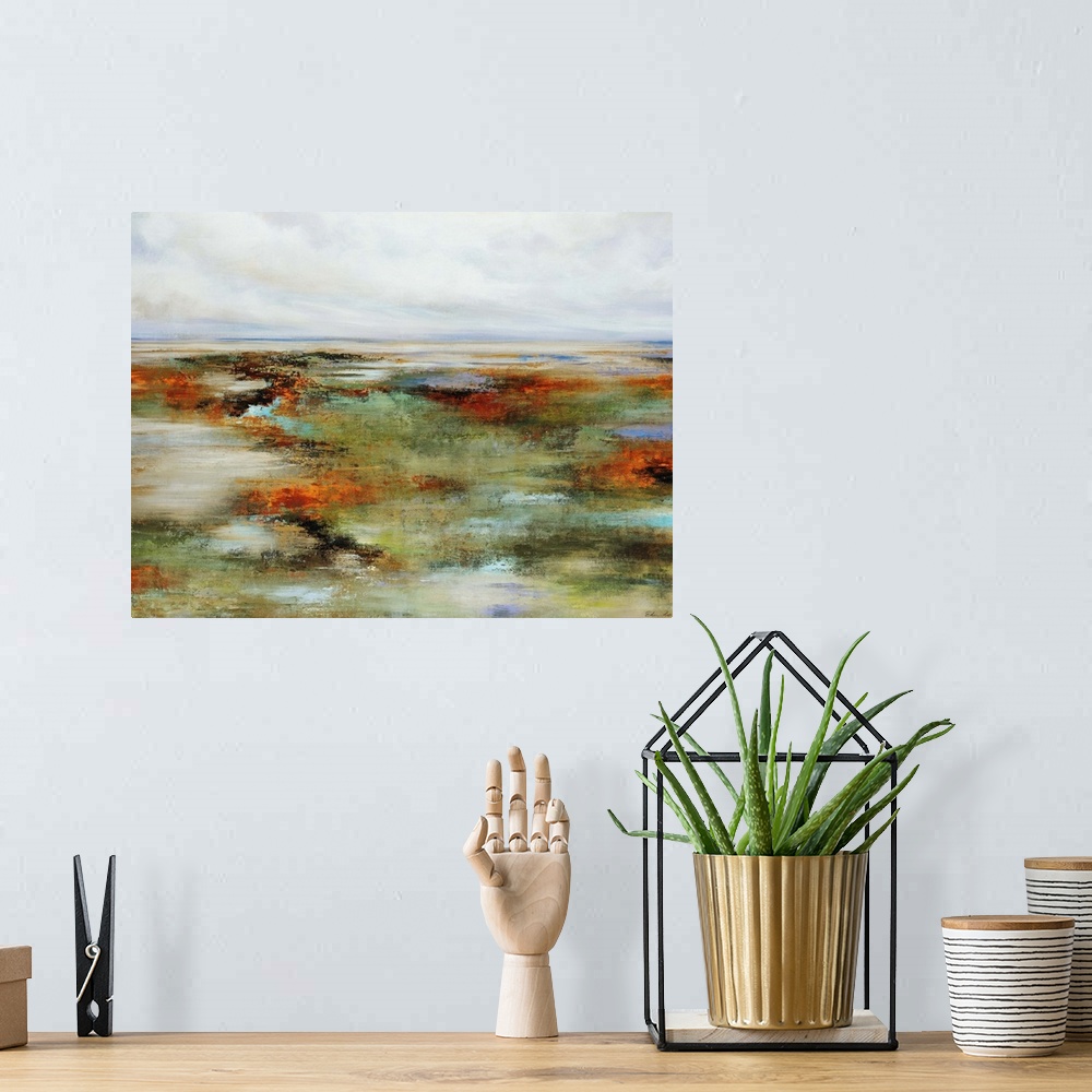 A bohemian room featuring Abstract painting of wetlands surrounded by a colorful landscape, beneath a blue sky full of fluf...