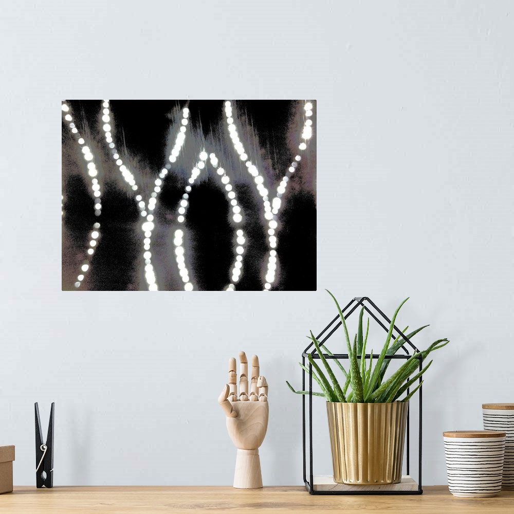 A bohemian room featuring An abstract of curved bright diamond dot lights on a silver, gold and black background.