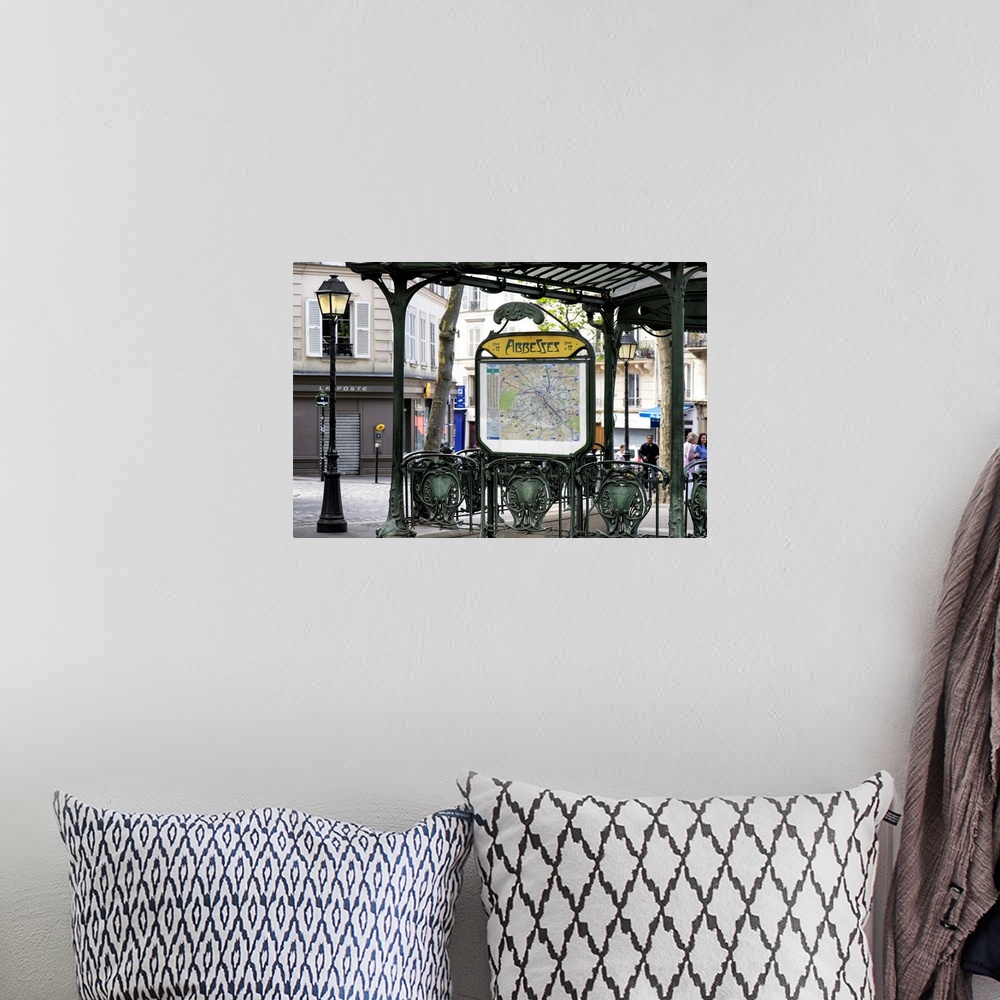 A bohemian room featuring A photograph of the Abbesses subway station sign in Paris.