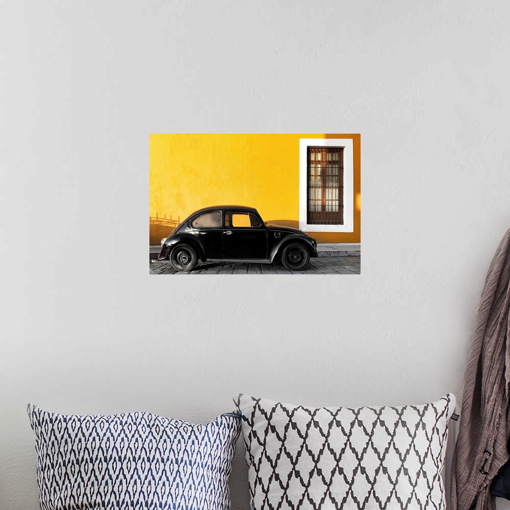 A bohemian room featuring Photograph of a black Volkswagen Beetle parked on the street in front of a gold exterior wall. Fr...