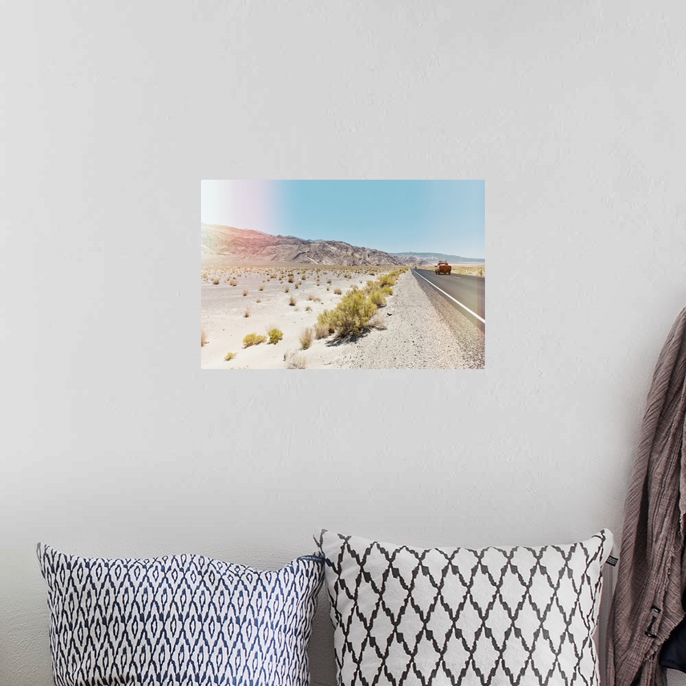 A bohemian room featuring A photograph in soft faded pastel colors of a desert landscape in California.
