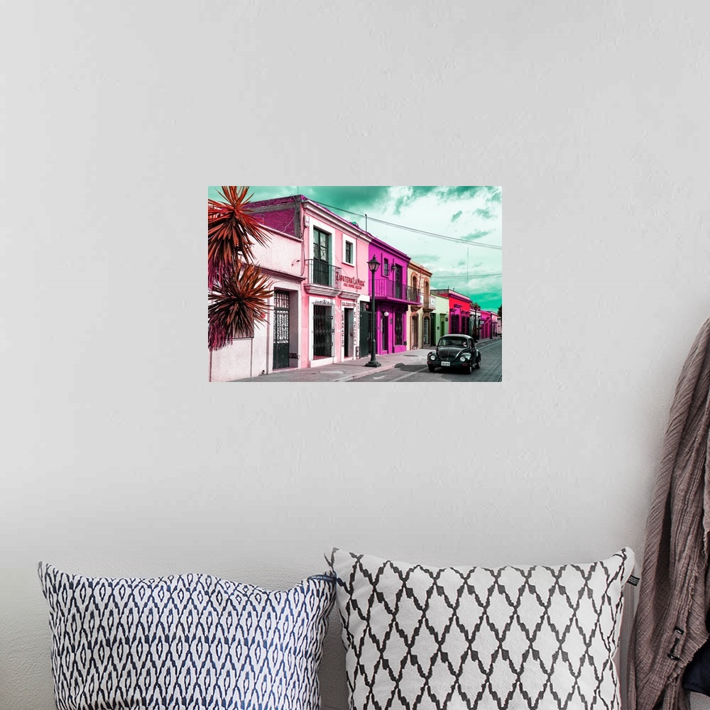 A bohemian room featuring Colorful photograph of pink facades and a black Volkswagen Beetle driving down the street. From t...