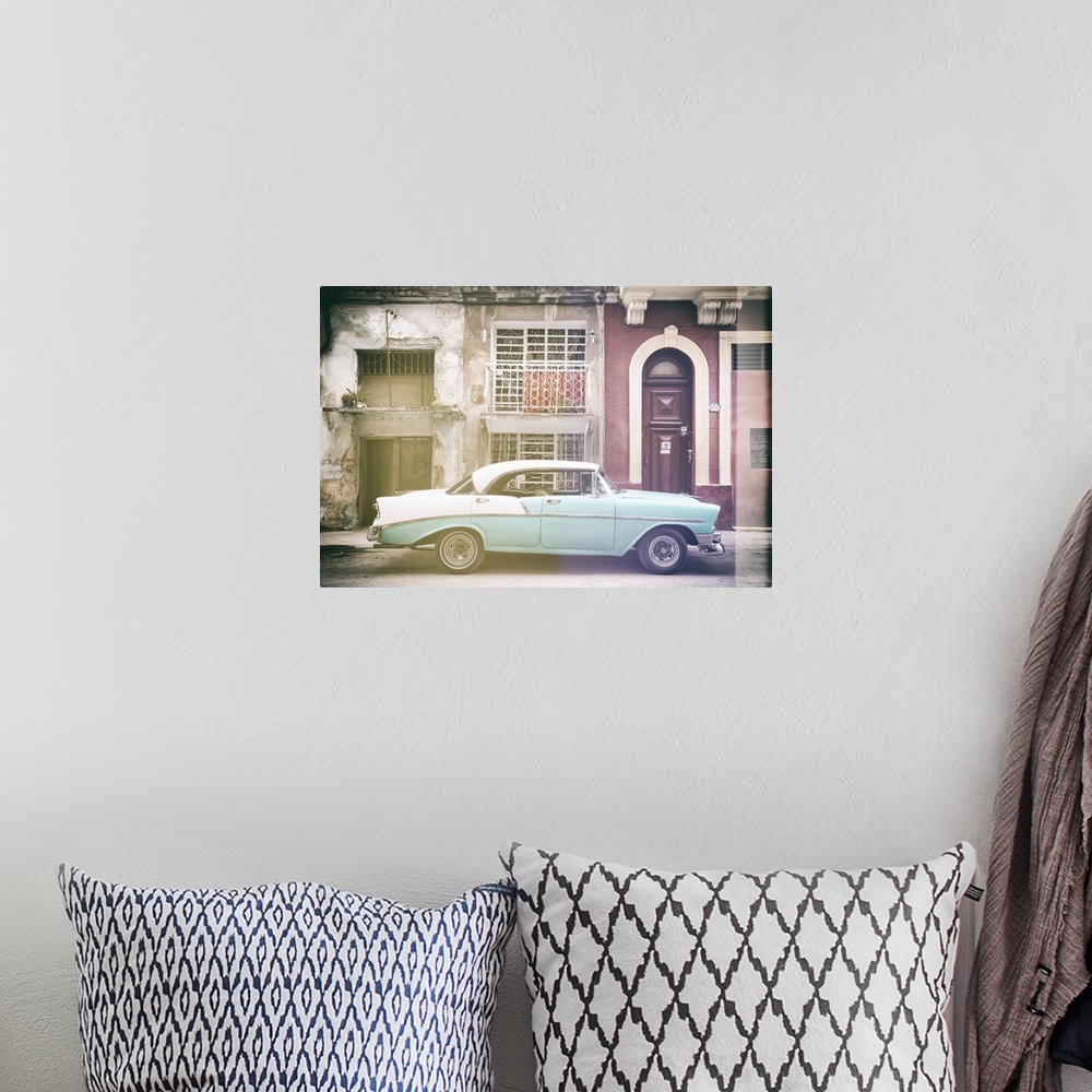 A bohemian room featuring Faded photograph of a turquoise and white vintage card parked on the side of a street in Havana w...