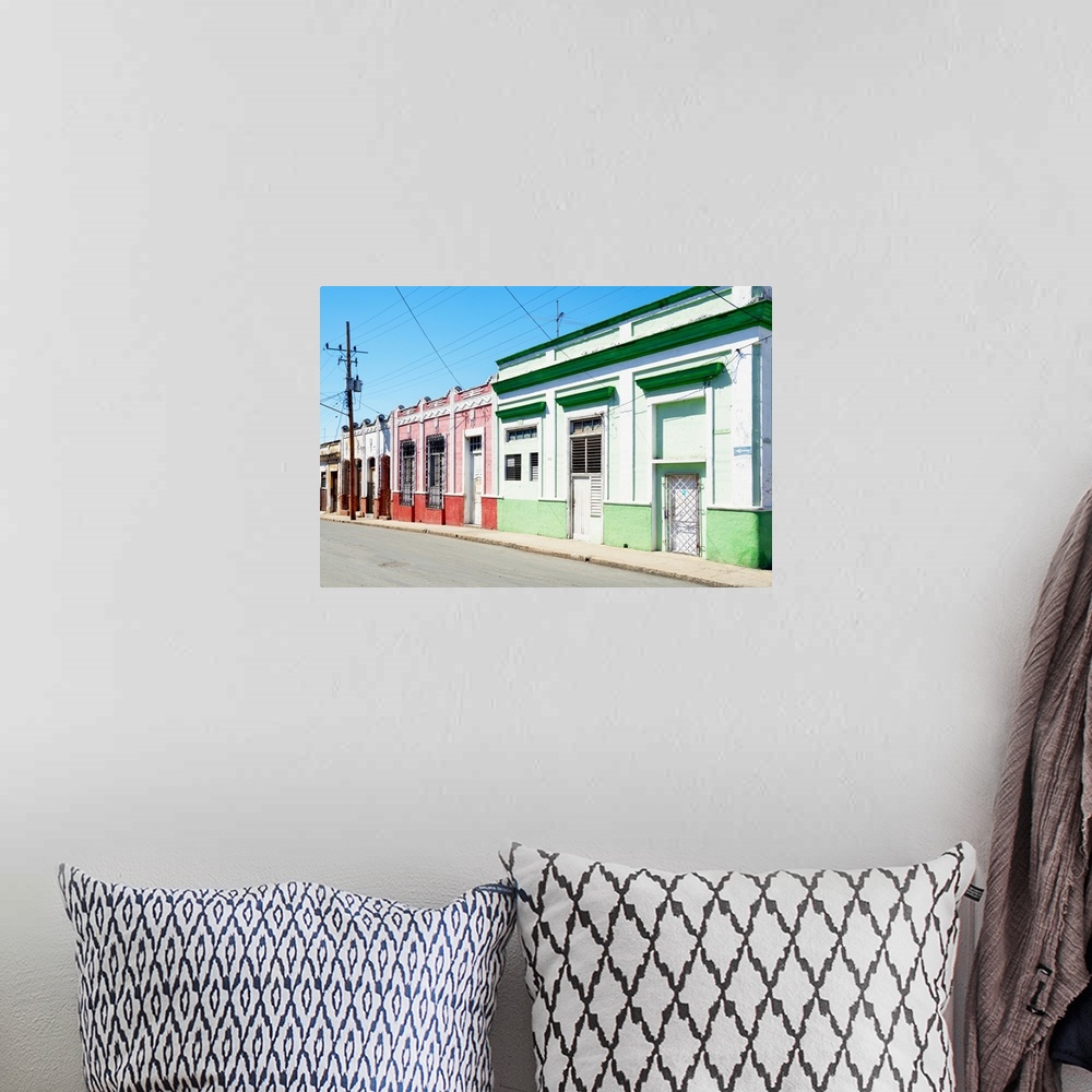 A bohemian room featuring Photograph of a Havana streetscape with colorful facades lining the road.