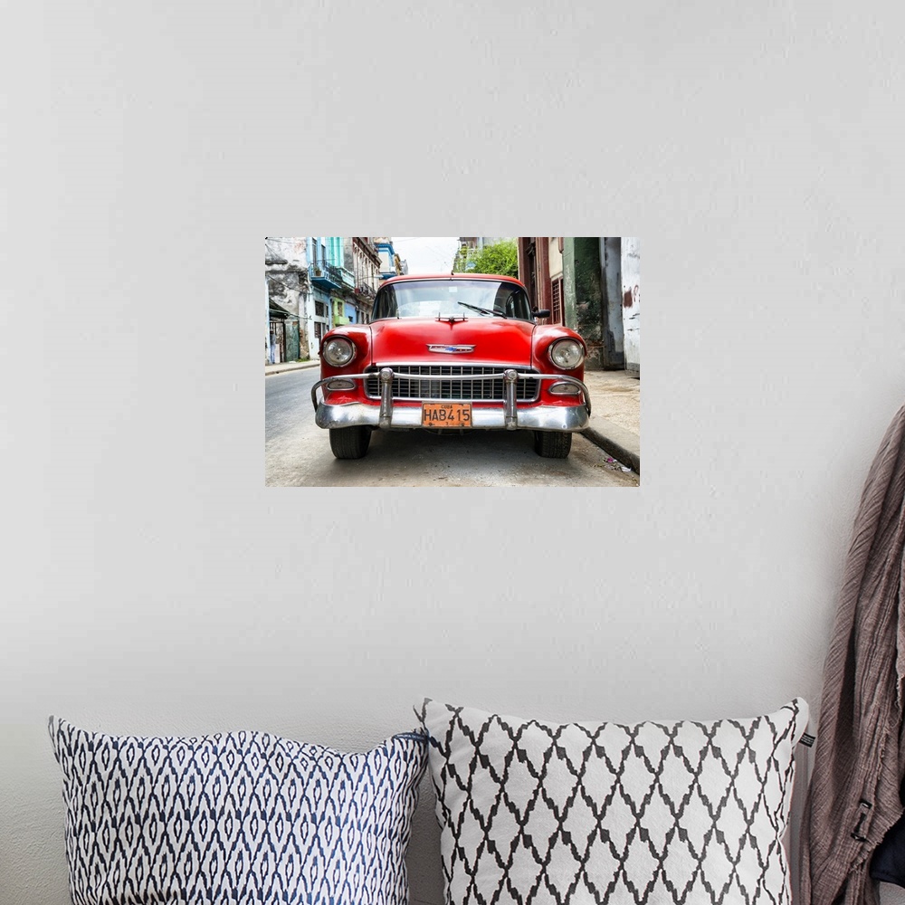 A bohemian room featuring Photograph of the front of a red vintage Chevrolet.