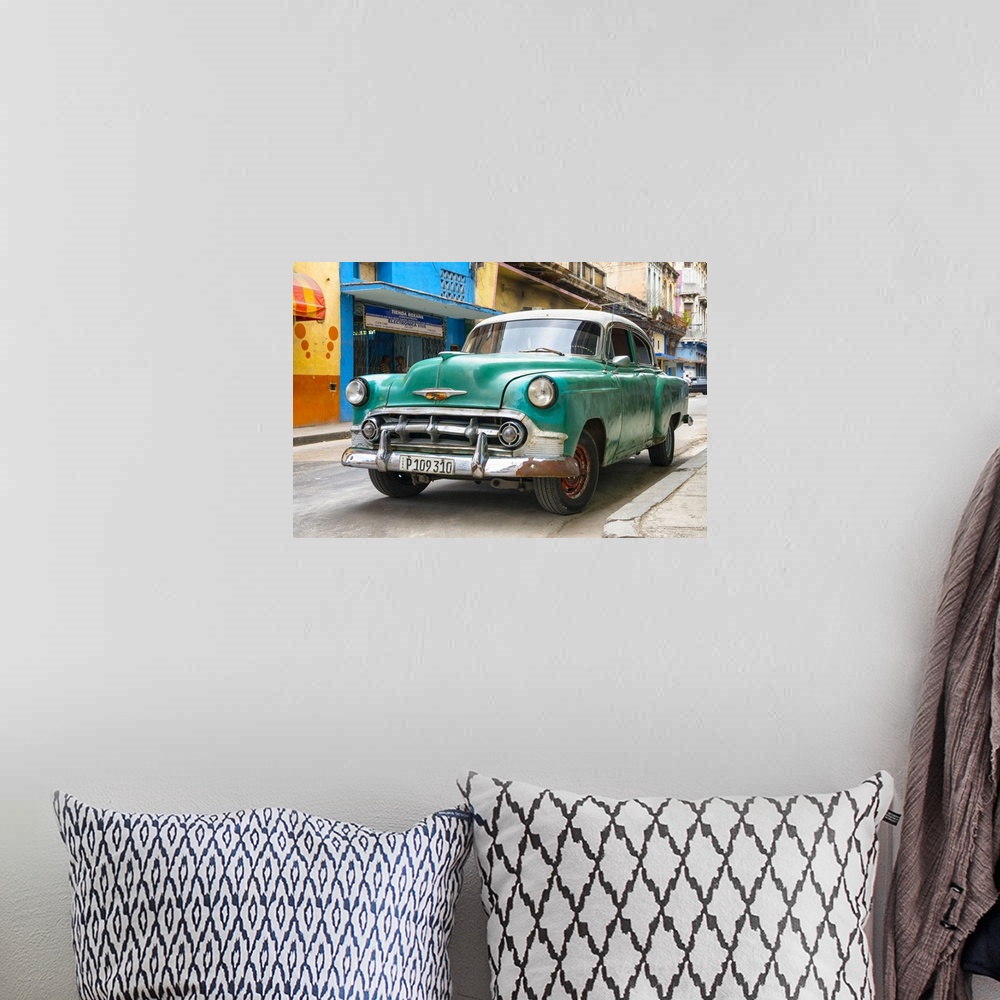 A bohemian room featuring Photograph of the front of a green vintage Chevrolet.